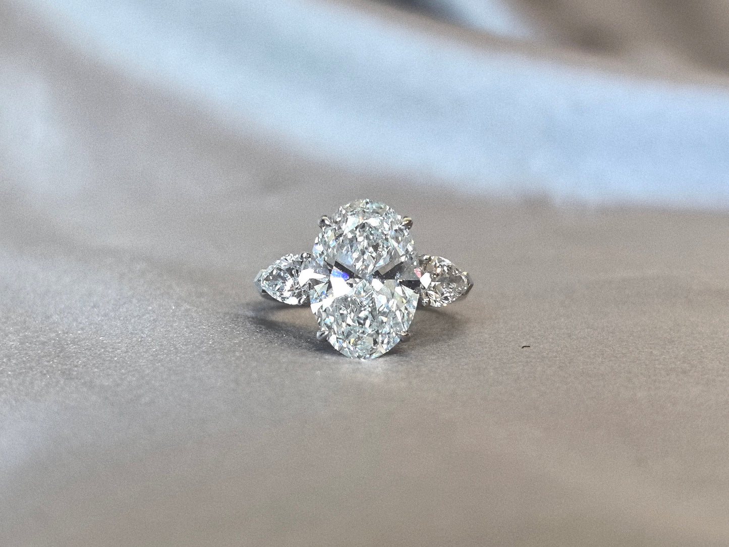 Oval-Center Trilogy Ring with Pear Sidestones